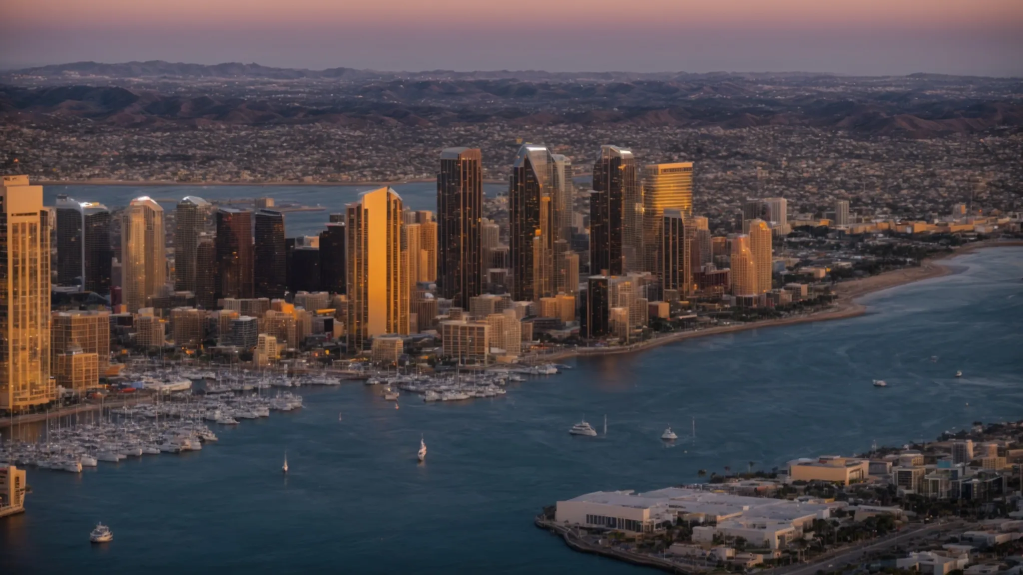 the skyline of san diego at sunset, highlighting the dynamic intersection of the city's economic landscape and the pacific coast.