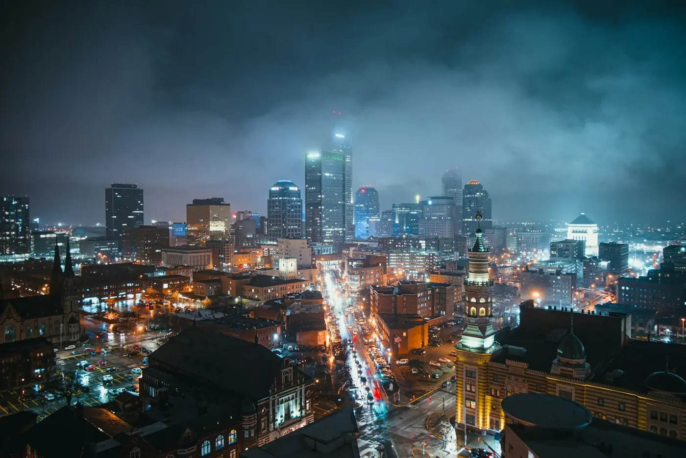 Downtown Indianapolis skyline and city streets lit up at night